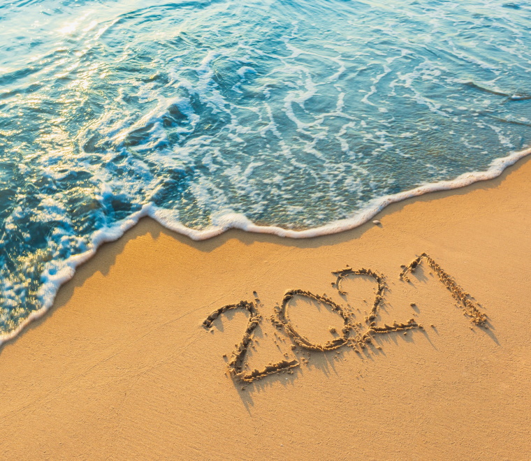 2021 drawn in the sand on a beach