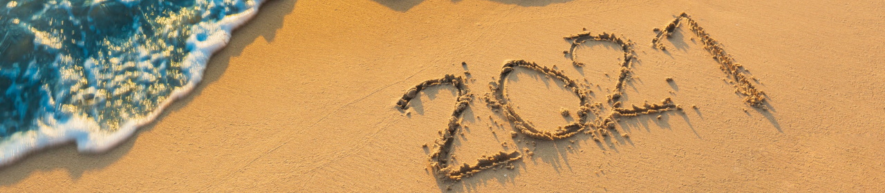 2021 drawn in the sand on a beach